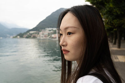 Close-up portrait of young woman looking away