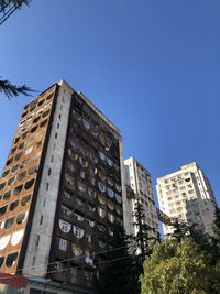 Low angle view of modern buildings connected with a brodge 