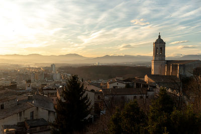 As the sun sets over the medieval walls of girona in catalunya, spain, 