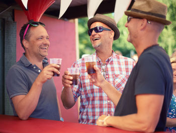 Male friends enjoying drinks at party