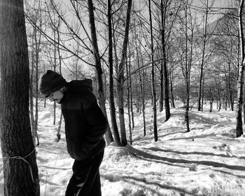 Full length of man holding snow covered trees