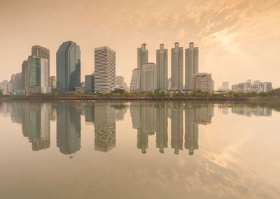 Reflection of buildings in lake against sky