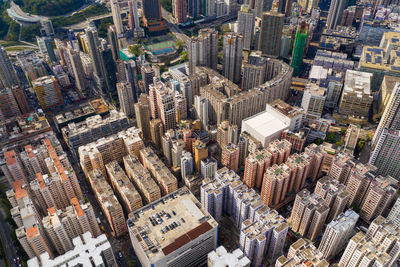 Aerial view of buildings in city against sky