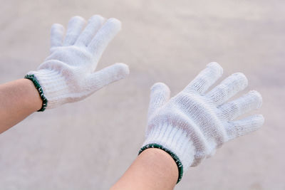 Cropped hands of person wearing gloves