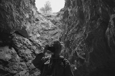 Man photographing rocks on rock formation