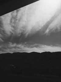 Scenic view of mountains against cloudy sky