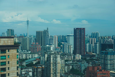 Aerial view of modern buildings in city against sky