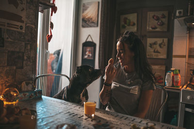 Midsection of woman with drink on table