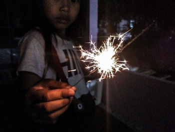 Low angle view of firework display at night