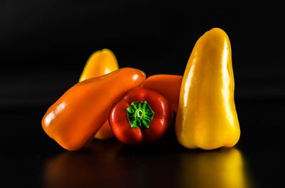 Close-up of yellow bell peppers against black background