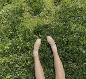 Low section of woman relaxing on field