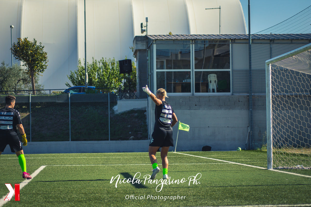 FULL LENGTH OF BOY PLAYING WITH UMBRELLA ON GRASSLAND