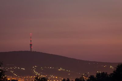 Illuminated tower against sky at night