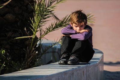 Portrait of teenage girl sitting outdoors