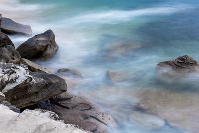 Rocks in sea against sky