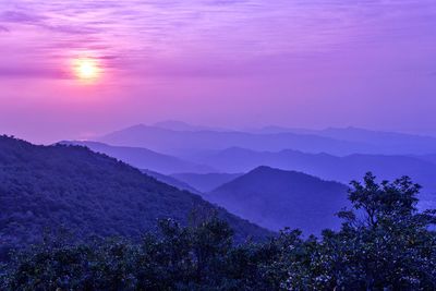 Scenic view of mountains against sky at sunset