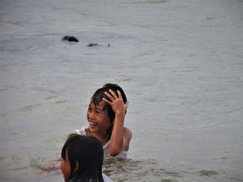 Full length of shirtless woman in sea