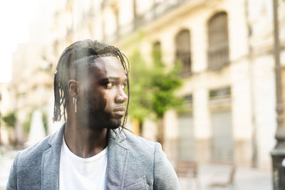 Young man standing in city