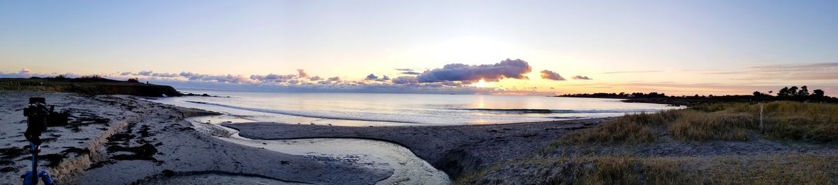 Panoramic view of sea against sky during sunset