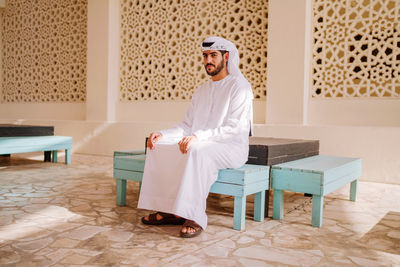 Full length of man sitting on chair