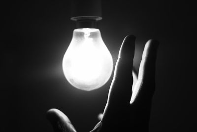 Close-up of light bulb against black background