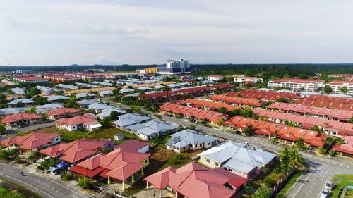 High angle view of houses in town against sky