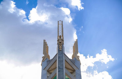 Low angle view of tower against blue sky