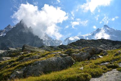 Scenic view of mountain range against cloudy sky