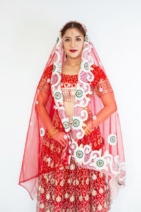 Woman standing against red background