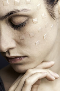 Close-up of young woman with beauty product