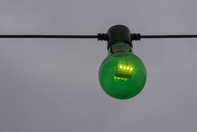 Close-up of light bulb against wall