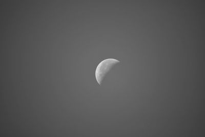 Low angle view of half moon against sky at night