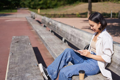 Young woman sitting on bench