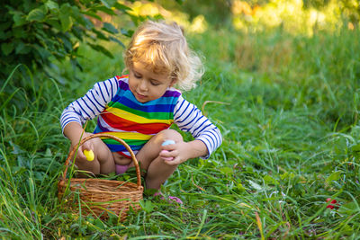 Portrait of cute girl sitting on field