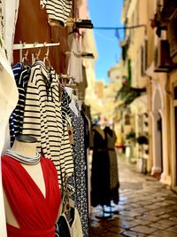 Clothes hanging on street amidst buildings in city