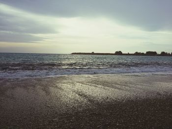 Scenic view of sea against cloudy sky