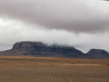 Scenic view of arid landscape against sky