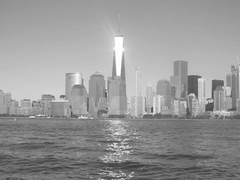 River against one world trade center amidst towers at manhattan