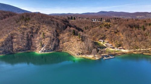 Scenic view of river amidst mountains against sky