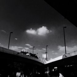 Low angle view of bridge against cloudy sky