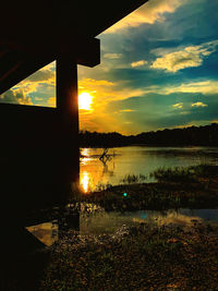 Scenic view of lake against orange sky