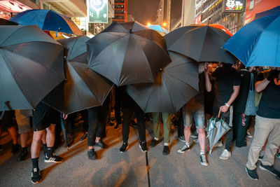 People walking on wet street in city