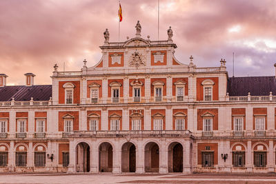 Low angle view of building against cloudy sky