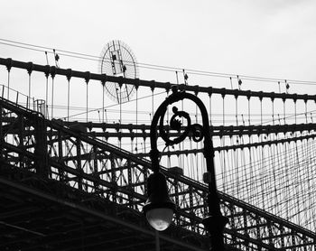 Low angle view of silhouette bridge against sky