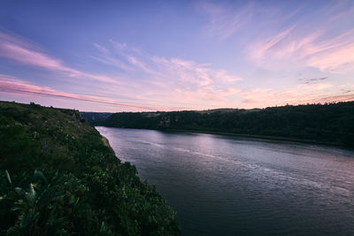 Scenic view of river against sky during sunset