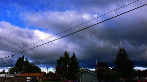 Low angle view of trees and buildings against sky