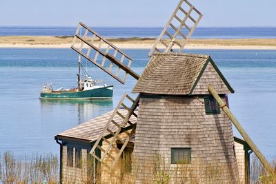 Fishing boat and wind mill at chatham, cape cod.