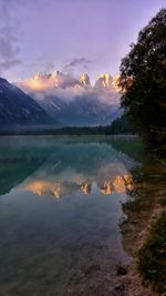 Mountains reflecting in lake against sky