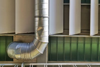 Close-up of pipes against wall in factory