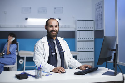 Portrait of doctor standing in office